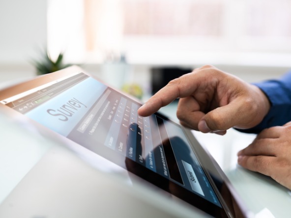 Person completing survey on tablet